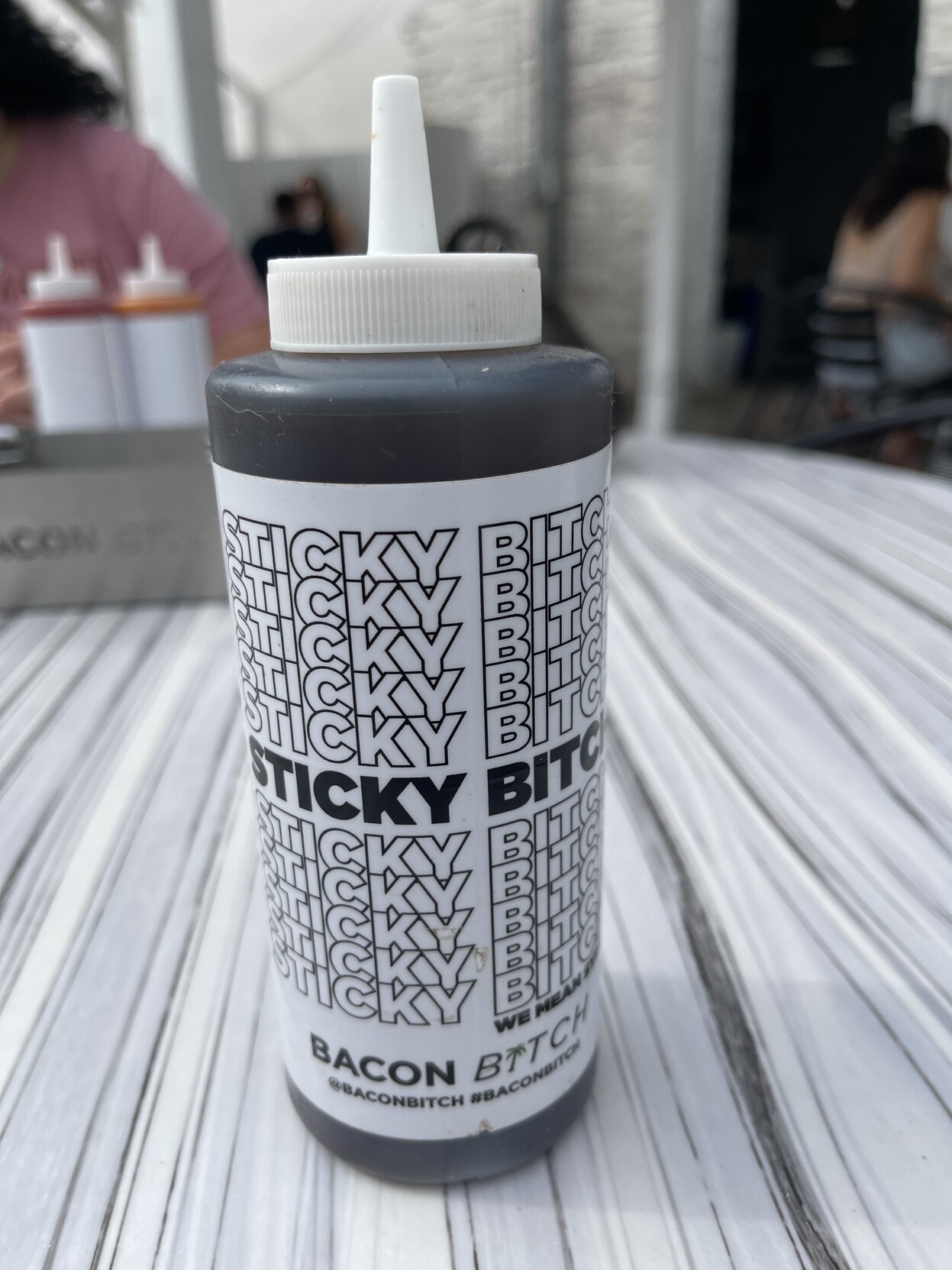 at a restaurant called “bacon bitch”, a bottle of syrup extravagantly labeled “sticky bitch”. 
