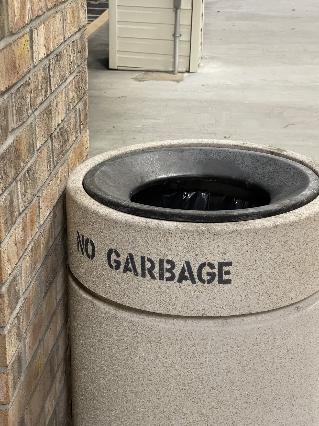 a garbage can marked “no garbage”